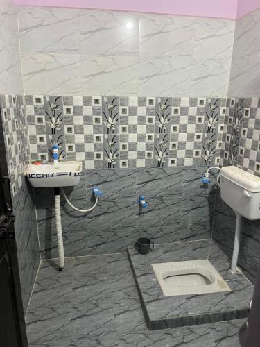 a bathroom with a sink and a toilet at Shyam Hotel & Janmasa in Rewa