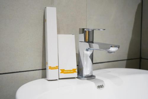 a faucet sitting on top of a white sink at Vi Grand inn in Satyamangalam