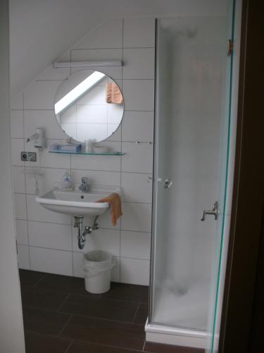 a bathroom with a sink and a mirror at Gasthaus zum Hirsch Hotel - Restaurant in Weier