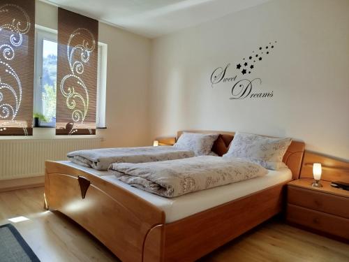 a bedroom with two beds and a sign on the wall at Ferienwohnung Brigatt in Klotten