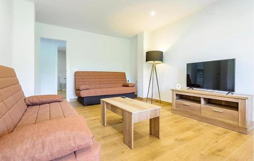 a living room with a couch and a flat screen tv at Apto Jérica in Jérica