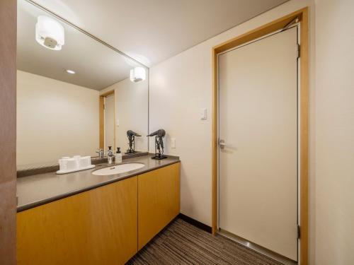 a bathroom with a sink and a mirror at KKR Hotel Hakata in Fukuoka