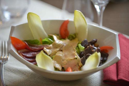 a white bowl of food on a table at Best Western Le Pont d'Or in Figeac