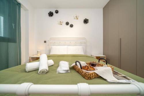 a bedroom with a bed with a basket of towels at New Amazing 2 bedroom flat near casino beach mall in Limassol