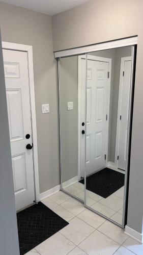 a mirror in a room with two doors at Home Sweet Home in Ottawa