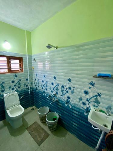 a bathroom with a toilet and a sink at Coorg Nature vista in Kushālnagar