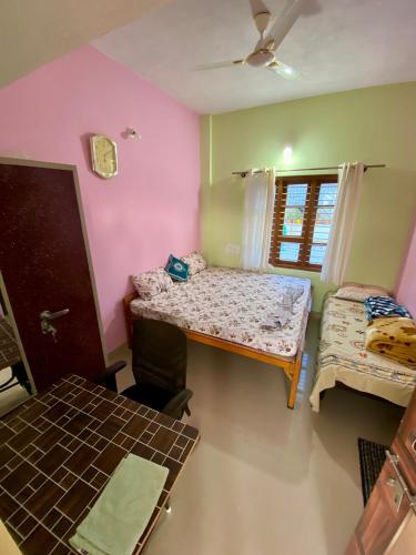 a room with a table and a bed and a window at Coorg Nature vista in Kushālnagar