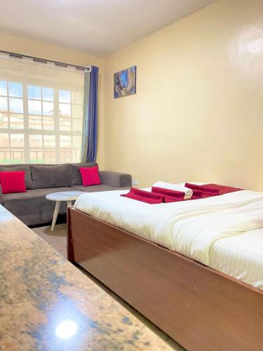 a living room with two beds and a couch at Kin Bnb in Ruaka