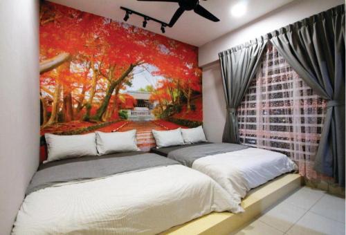 two beds in a room with a painting on the wall at Majestic Cottage in Ipoh
