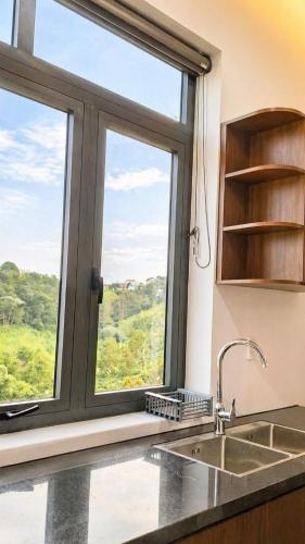 a kitchen with a large window and a sink at B'lao Eco Lodge in Bảo Lộc