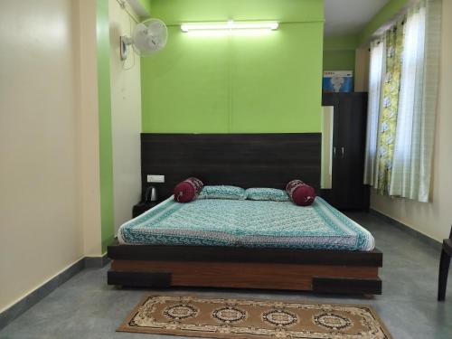 a bedroom with a bed in a green wall at Tree Valley Homestay Chail in Chail