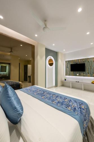 a large bed in a large room with a television at The Arjun - Newly Built Hotel Just 3 Mins from Metro and Railway Station in New Delhi