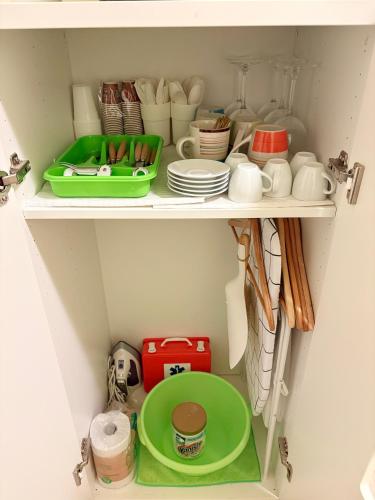a shelf with dishes and plates and other kitchen utensils at Casa di Sunshine in Ragusa