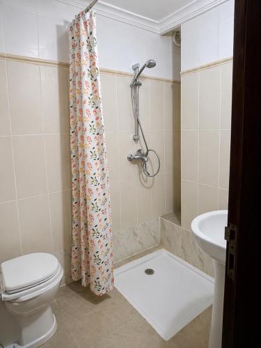 a bathroom with a toilet and a shower and a sink at Monica Place in Abidjan