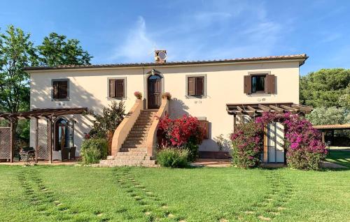 a large house with a lawn in front of it at Lovely Home In Tarquinia in Tarquinia