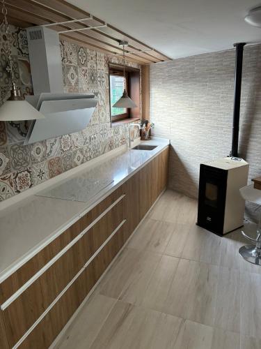 a kitchen with a counter and a stove in it at CHEPIBAROS Turismo in San Pedro