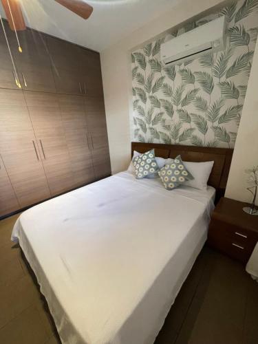 a bedroom with a large white bed with two pillows at Villa Balmoral in Peyia