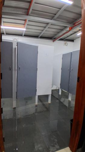 a row of stalls in a bathroom in a building at Starksway Resort in Calubcub Primero