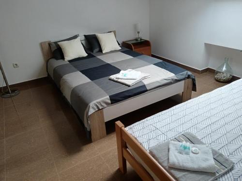 a bedroom with a bed and two beds in it at Mirni krov in Dražice