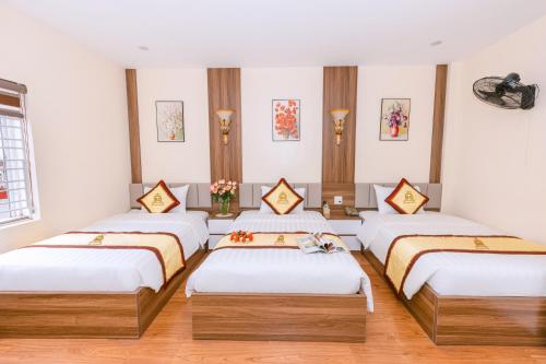 a room with four beds in a row at Kim Long Hotel Lao Cai - Near Hekou Border Gate in Lao Cai