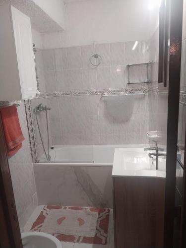 a bathroom with a tub and a sink and a shower at Siroco Nau Algarve in Olhão