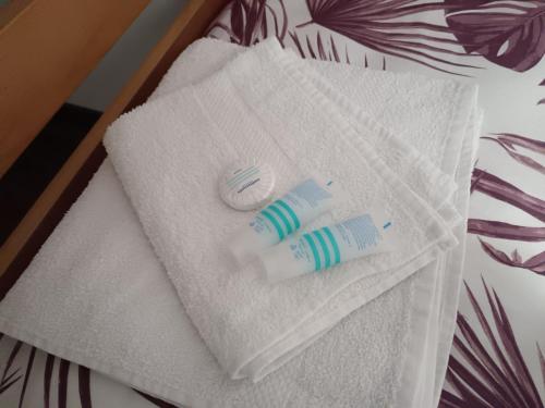 a couple of towels sitting on top of a bed at Mirni krov in Dražice