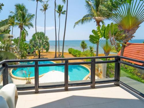 a view from the balcony of a resort with a swimming pool at Beachfront! 5 Bedrooms - Malee Beach Villa E1 in Ko Lanta