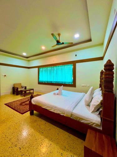 a bedroom with a bed with a ceiling fan at Richmount Natural Resort Pvt Ltd in Yercaud