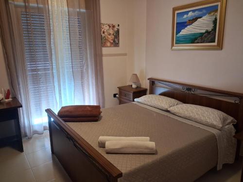 a bedroom with a bed with two towels on it at villa mediterranea in Realmonte