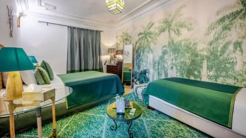 a hotel room with two beds and a couch at Riad & Spa Stella Cadente Marrakech in Marrakesh
