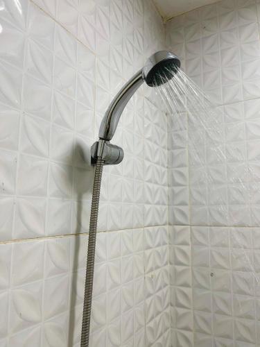a shower head with water coming out of it at Anders Arjuna Selatan in Jakarta