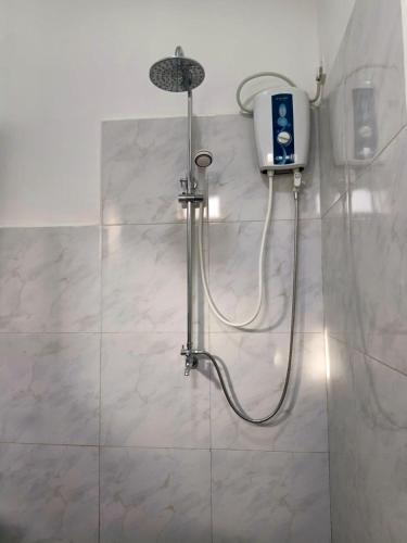 a shower with a shower head in a bathroom at Lake Edge Resort in Anuradhapura
