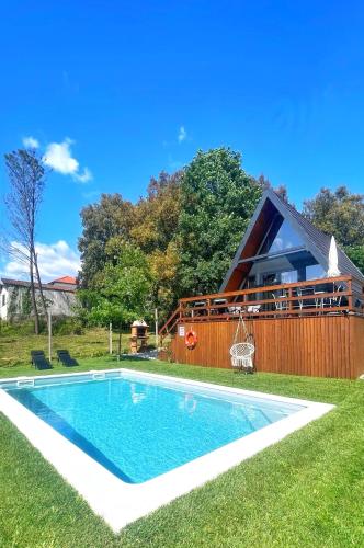 a swimming pool in the yard of a house at Chalés Luna in Rio Chalé Lua in Ponte da Barca