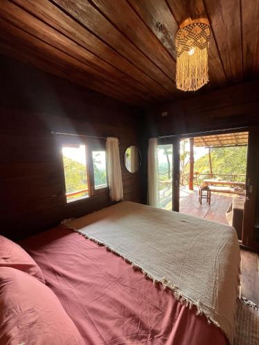 a bedroom with a large bed in a room with windows at Sunset Sea View House Large Terrace 2BR in Ban Nok