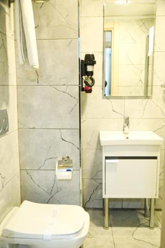 a bathroom with a toilet and a sink at Hatay Hotel in Istanbul