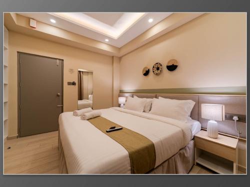 a bedroom with a large bed in a room at Aywa Hotels Edapally in Cochin