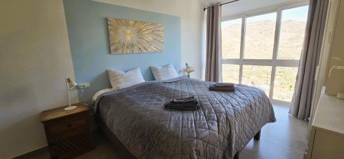 a bedroom with a bed with two towels on it at Casa Londi in Almuñécar