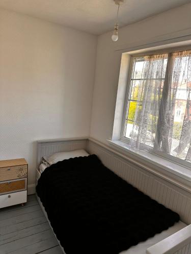 a bed in a room with a window at 5 Bedroom house Doncaster in Balby