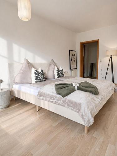 a bedroom with a large white bed with pillows at Auszeit in Bullay