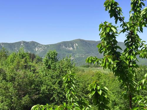 a view of the mountains from the forest at Villa Doubledot in Piane di Montorio