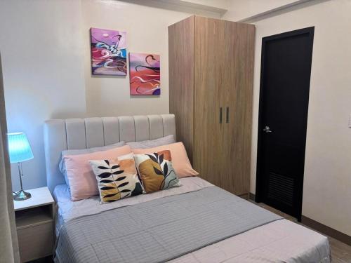 a bedroom with a bed with pillows on it at Polished Studio at The Verdin Maple Grove in General Trias