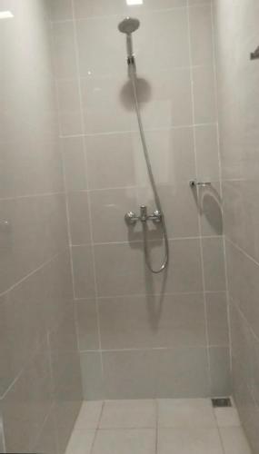 a shower in a bathroom with a glass door at Polished Studio at The Verdin Maple Grove in General Trias
