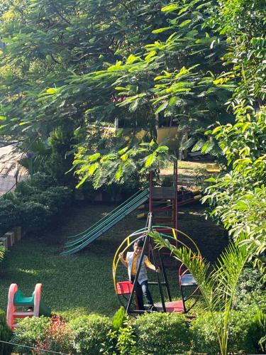a person riding a roller coaster in a playground at North Queen Resort in Mal bazar