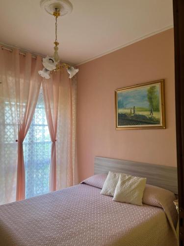 a bedroom with a bed and a window at VILLA FELICE in Loano