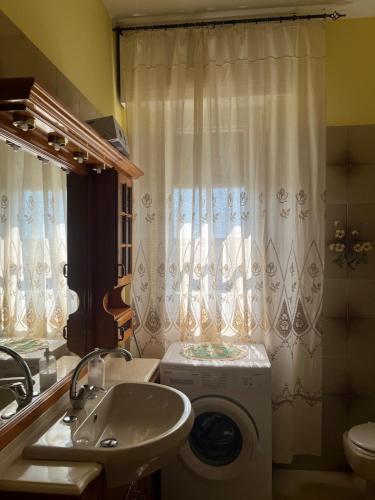 a bathroom with a washing machine and a sink at VILLA FELICE in Loano