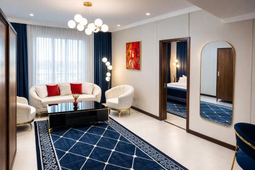 a living room with a couch and a mirror at Рамада Нукус in Nukus