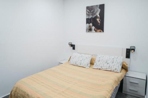 a bedroom with a bed with two pillows on it at Apart LA PLANA II in Castellón de la Plana