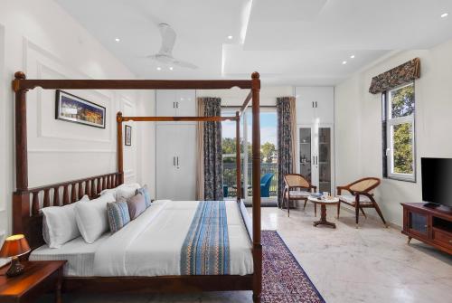 a bedroom with a bed and a living room at Jolawas Stays Udaipur in Udaipur