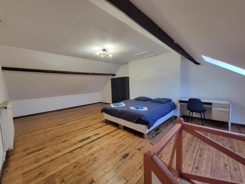 a bedroom with a bed and a desk in it at Maison proche gare in Margny-lès-Compiègne