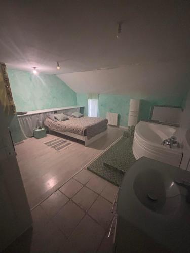 a bathroom with a bed and a toilet in a room at maison de loire in Villebernier